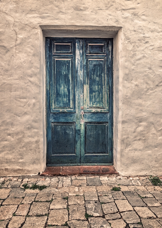 Blue door in white stone wall
