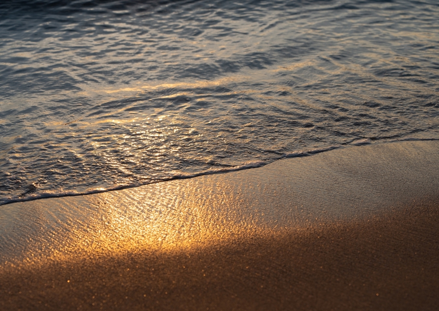 Sea water meets golden sand