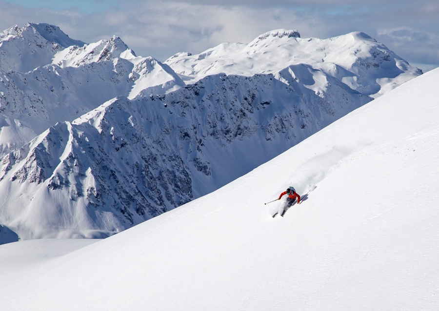 Skier with a view in the Alps