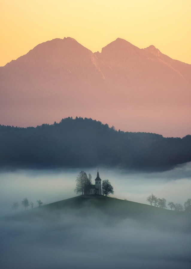 Slovenian church above the fog