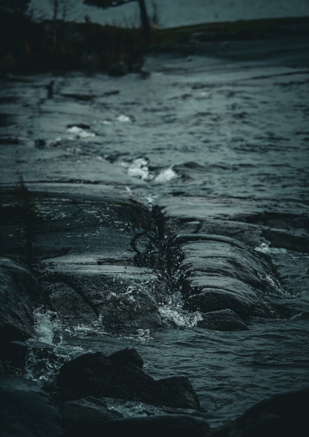 Stormy water against rocks