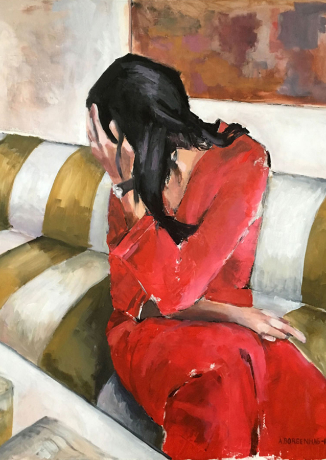 Woman In A Red Dress Sits On A Sofa