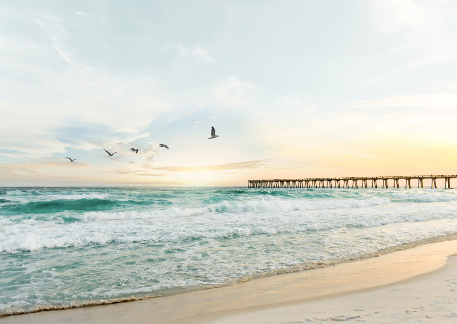 Serene Sunset Over Ocean Waves and Pier